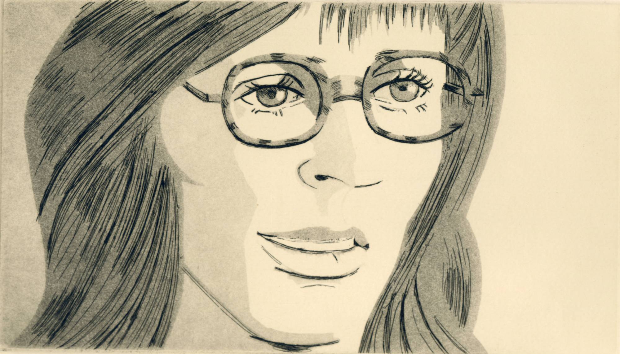 close up of young woman's face smiling with glasses